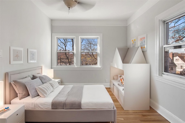 bedroom featuring ceiling fan and light hardwood / wood-style flooring