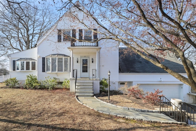 view of front of property featuring a garage and a balcony