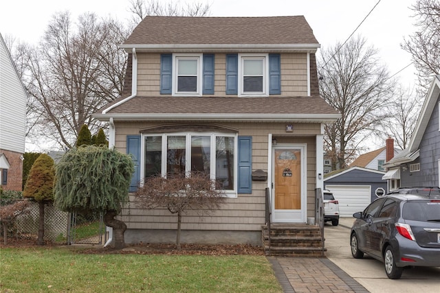 view of front facade featuring an outdoor structure and a garage