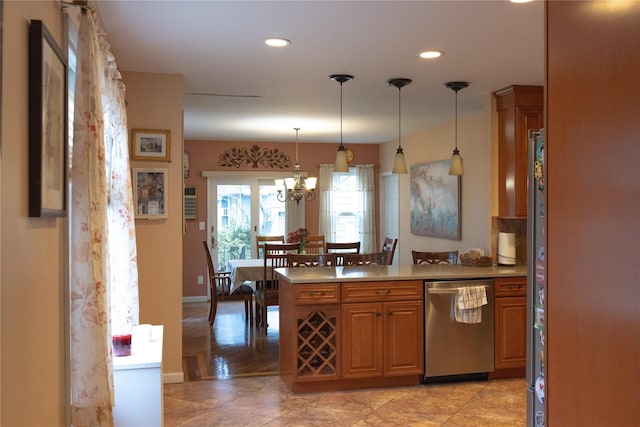 kitchen with dishwasher, a notable chandelier, pendant lighting, kitchen peninsula, and light tile patterned floors