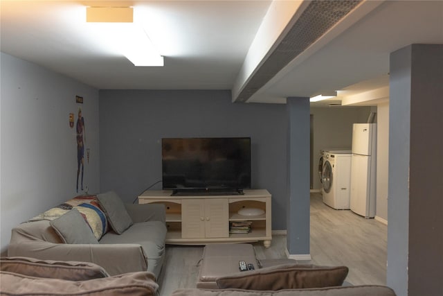 living room featuring light hardwood / wood-style floors and independent washer and dryer