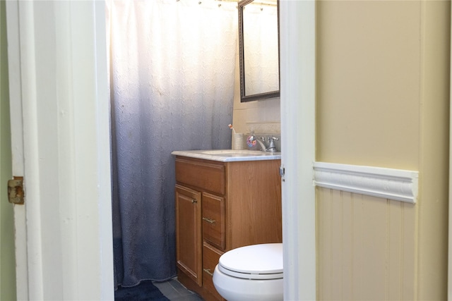 bathroom featuring toilet and vanity