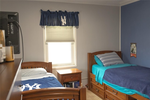 carpeted bedroom with ornamental molding