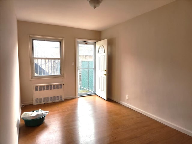 interior space with radiator and light hardwood / wood-style floors