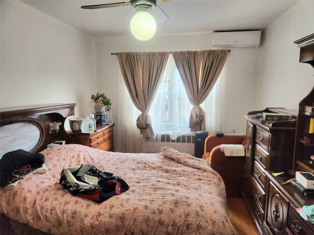 bedroom with hardwood / wood-style flooring, radiator, a wall mounted air conditioner, and ceiling fan