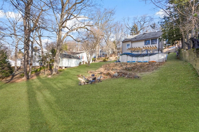 view of yard with a covered pool