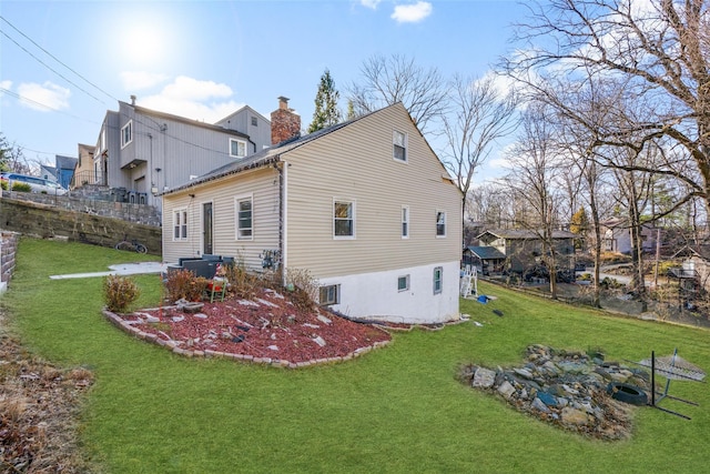 back of house with a lawn