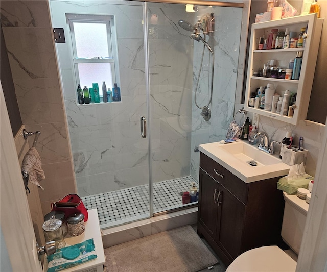 bathroom with a shower with shower door, vanity, decorative backsplash, and toilet