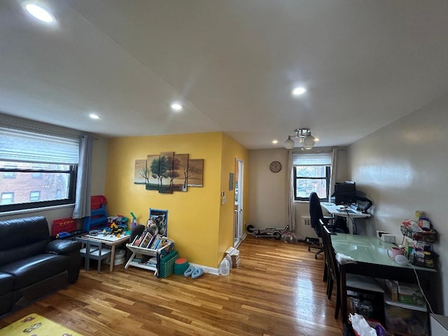 living room with wood-type flooring and an inviting chandelier