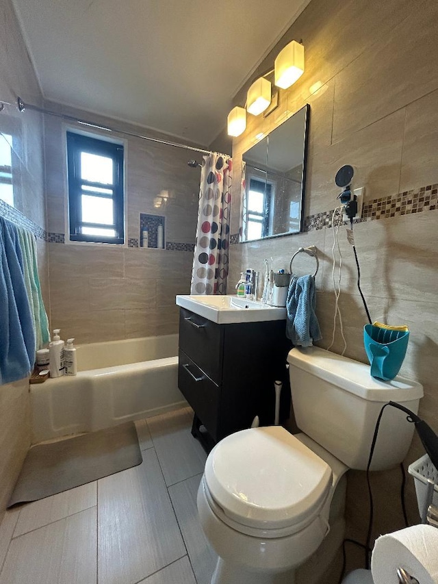 full bathroom featuring toilet, vanity, tile patterned flooring, tile walls, and shower / bath combination with curtain