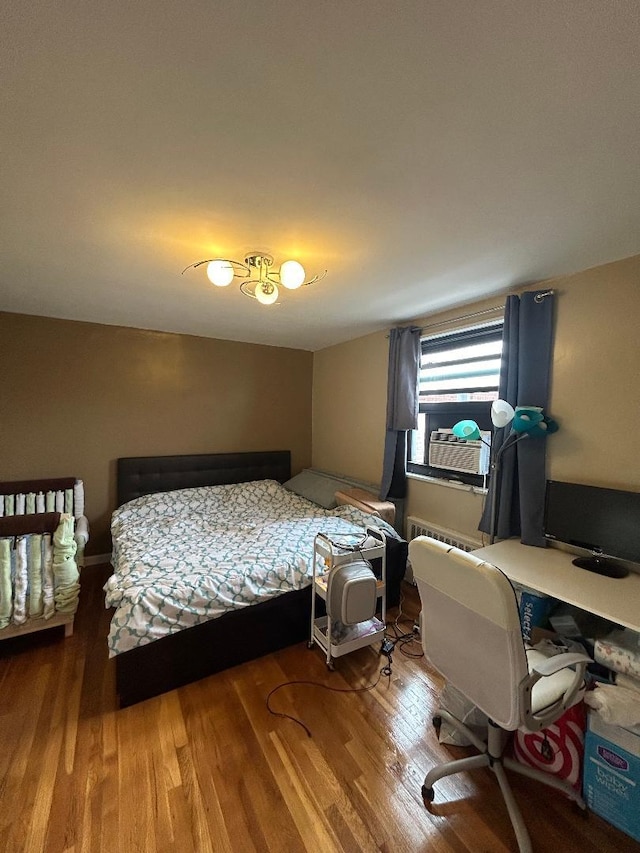 bedroom with hardwood / wood-style floors