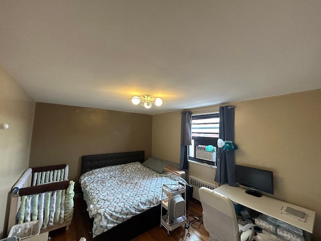 bedroom featuring radiator and wood-type flooring