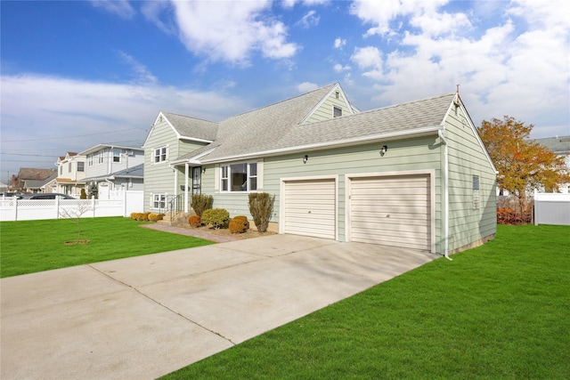 view of front of house with a front yard and a garage