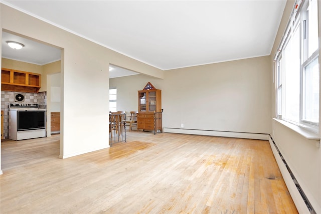 unfurnished living room featuring light wood-type flooring and baseboard heating