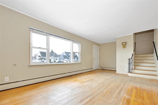 unfurnished living room featuring baseboard heating and light hardwood / wood-style flooring