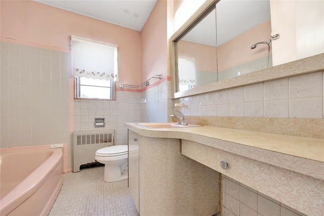 full bathroom featuring radiator heating unit, tile patterned floors, vanity, tile walls, and toilet