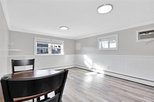 dining room featuring ornamental molding, a wall mounted AC, and light hardwood / wood-style flooring