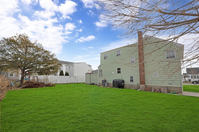 rear view of property with a lawn