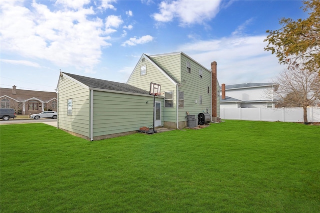 rear view of property featuring a yard