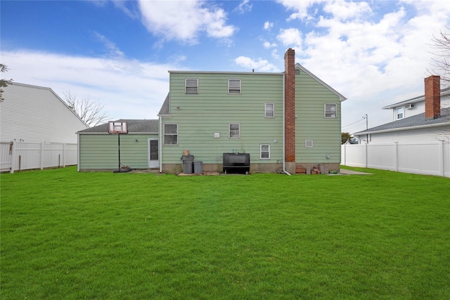 back of house featuring a yard