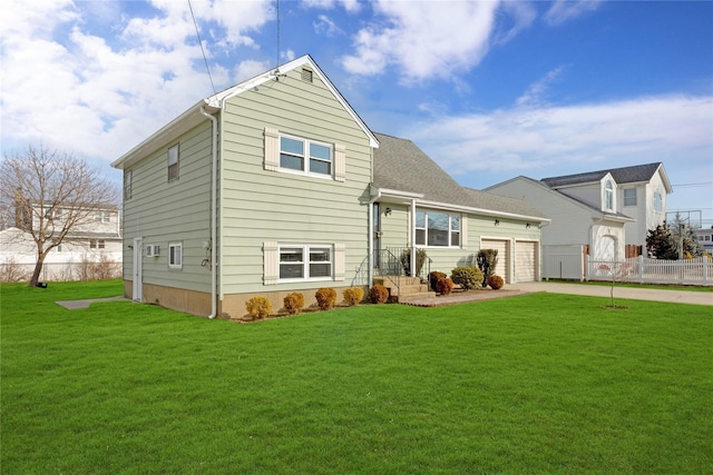 rear view of house with a garage and a yard