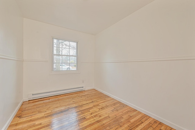 empty room featuring light hardwood / wood-style floors and a baseboard radiator