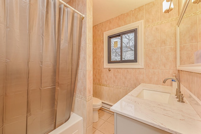 full bathroom featuring toilet, baseboard heating, tile walls, tile patterned floors, and vanity