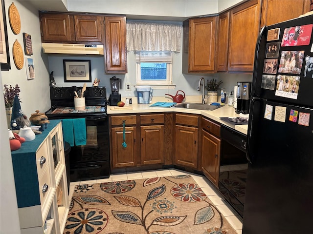 kitchen featuring sink, black appliances, and light tile patterned flooring