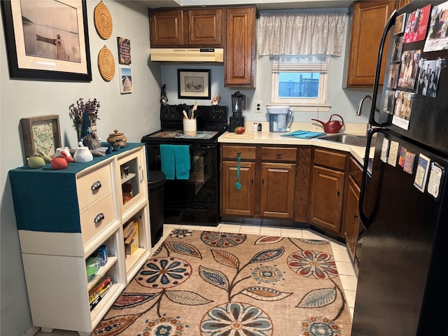 kitchen with black appliances, sink, and light tile patterned flooring