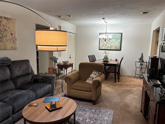 living room with a chandelier and carpet flooring