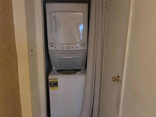 laundry room featuring stacked washer / drying machine