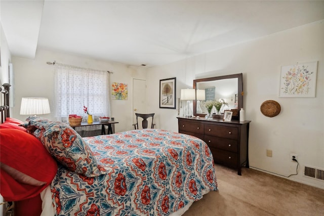 bedroom featuring light carpet and visible vents