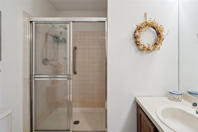 full bathroom with a tile shower and vanity