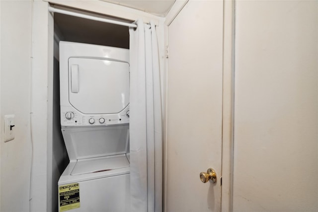 clothes washing area with laundry area and stacked washing maching and dryer