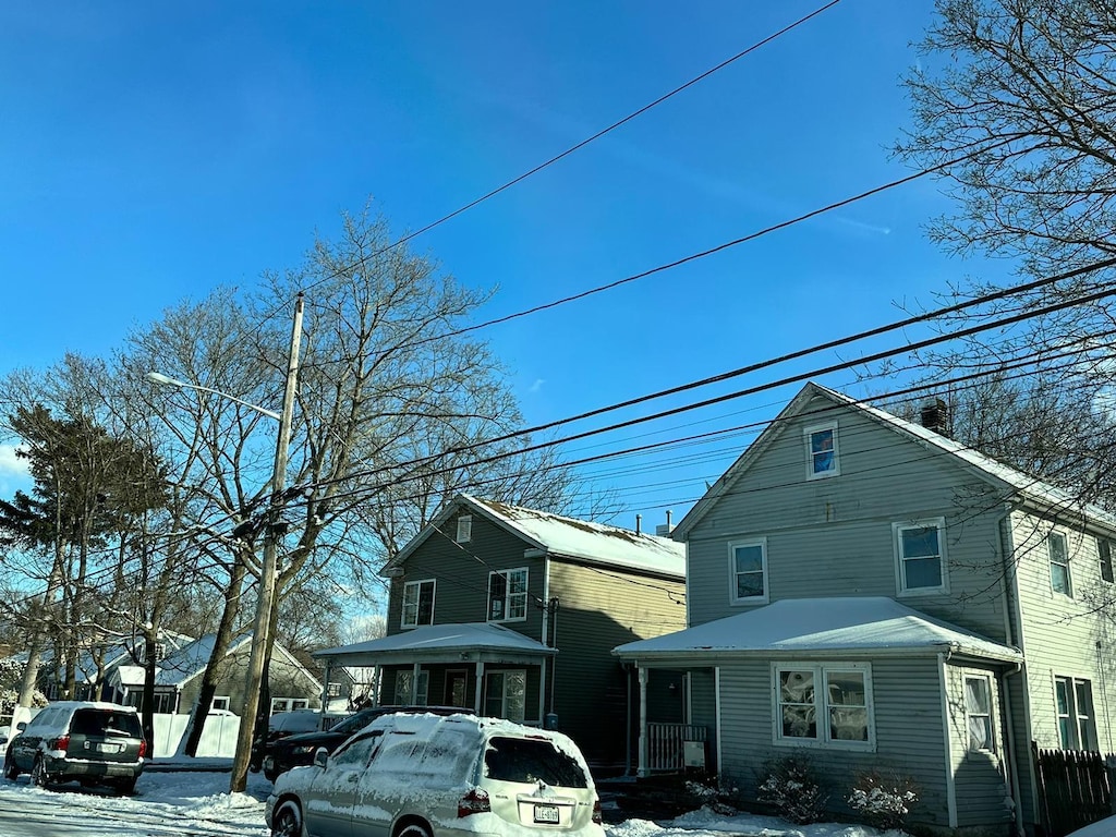 snow covered property with a porch