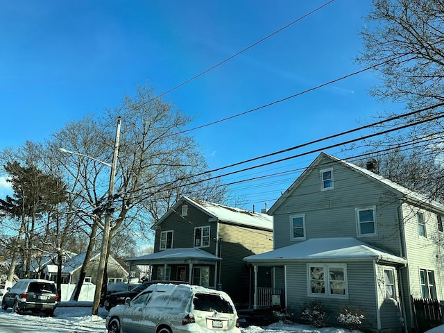 snow covered property with a porch