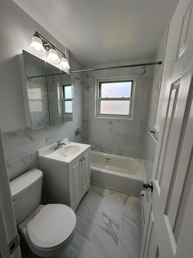 full bathroom with tiled shower / bath combo, vanity, and toilet