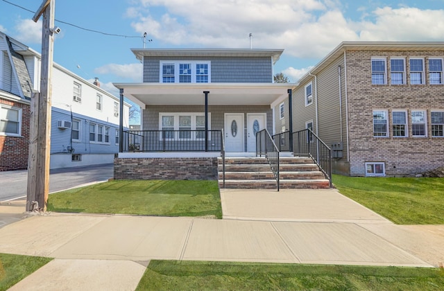 view of front of property with a front yard and a porch