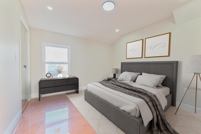 bedroom featuring light hardwood / wood-style flooring and vaulted ceiling