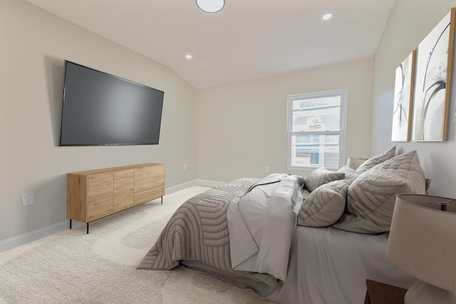 bedroom with lofted ceiling and light colored carpet