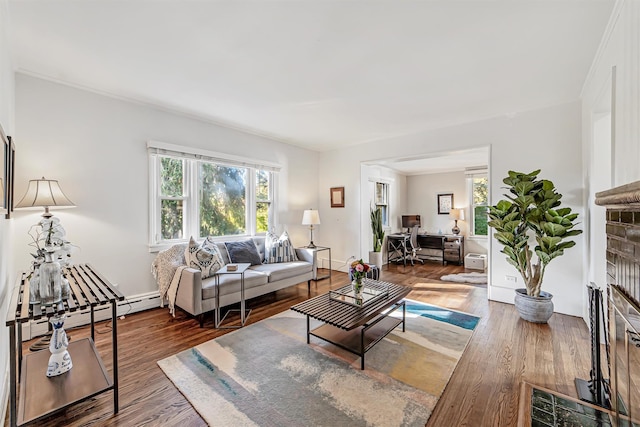 living area featuring a baseboard heating unit and wood finished floors