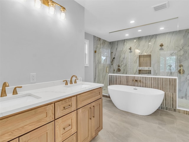 bathroom with vanity and shower with separate bathtub