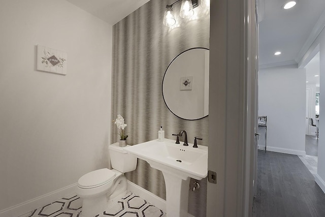 bathroom with toilet and hardwood / wood-style flooring