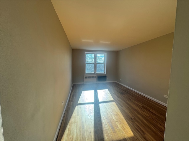 spare room featuring dark wood-type flooring