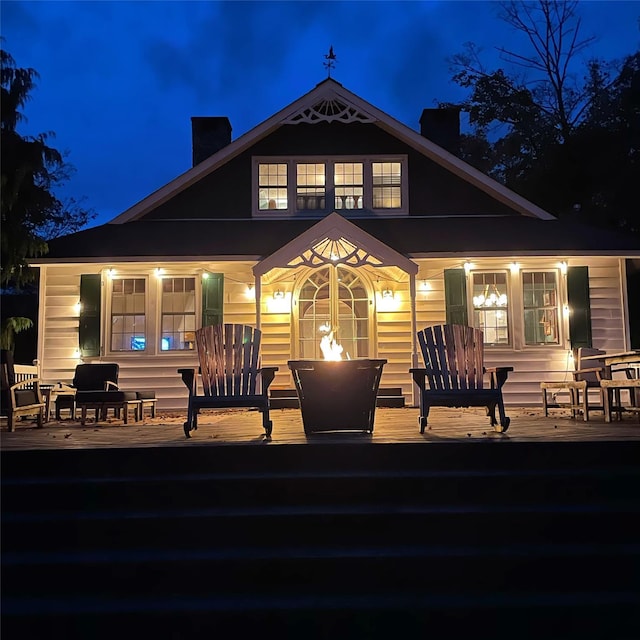 back house at night with a wooden deck