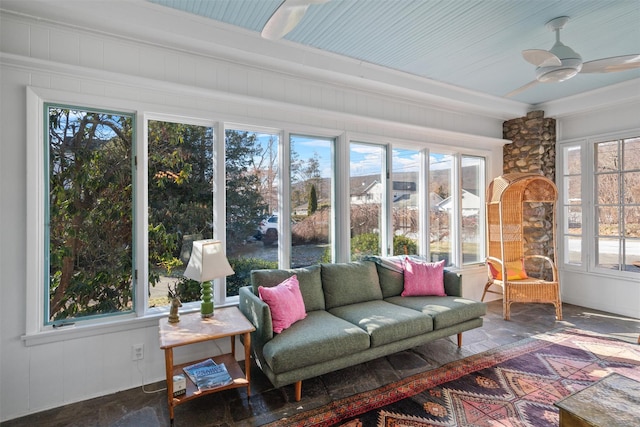 sunroom featuring ceiling fan