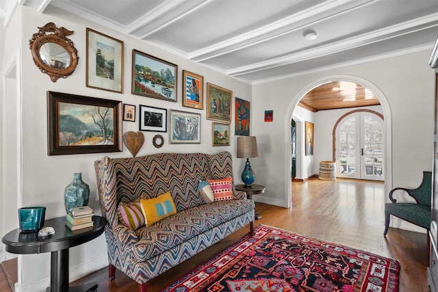 living room with light wood-type flooring, french doors, beamed ceiling, and crown molding