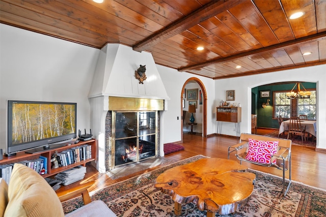 living room with wooden ceiling, wood-type flooring, beamed ceiling, and a chandelier