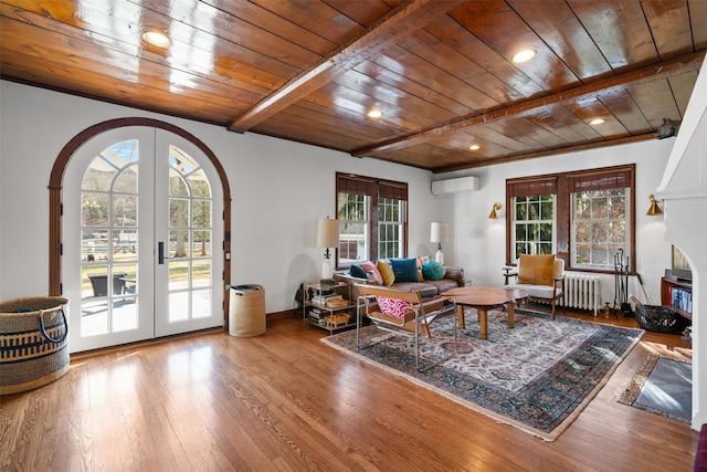 living room with an AC wall unit, french doors, radiator heating unit, and wood ceiling