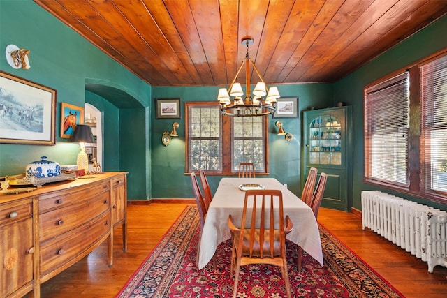 dining room featuring wooden ceiling, a chandelier, hardwood / wood-style flooring, and radiator heating unit